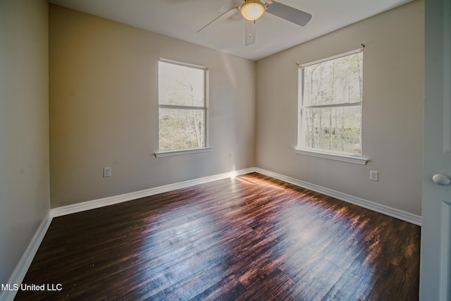 unfurnished room featuring wood finished floors, a ceiling fan, and baseboards