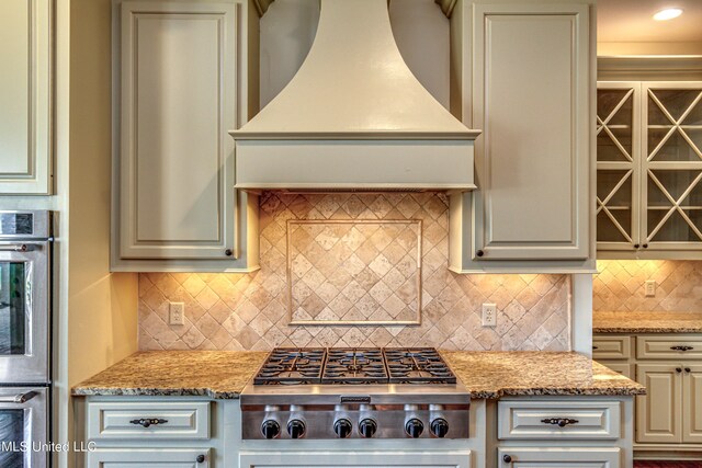2024 E Northside Dr, Jackson, MS 39211 - kitchen featuring custom exhaust hood, decorative backsplash, appliances with stainless steel finishes, and light stone countertops