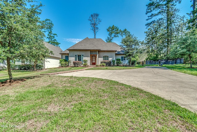 2024 E Northside Dr, Jackson, MS 39211 - view of front of house featuring stucco siding, a front lawn, fence, and a shingled roof