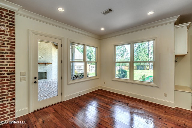 2024 E Northside Dr, Jackson, MS 39211 - doorway featuring dark wood-style flooring, baseboards, visible vents, crown molding, and a fireplace