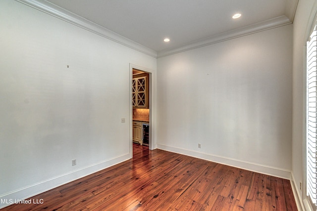 2024 E Northside Dr, Jackson, MS 39211 - spare room featuring crown molding, beverage cooler, and dark wood-type flooring