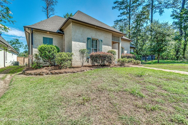 2024 E Northside Dr, Jackson, MS 39211 - view of front facade with stone siding, a front lawn, stucco siding, and fence
