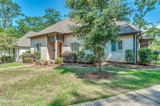 2024 E Northside Dr, Jackson, MS 39211 - view of front of property featuring fence, roof with shingles, a front yard, and stucco siding