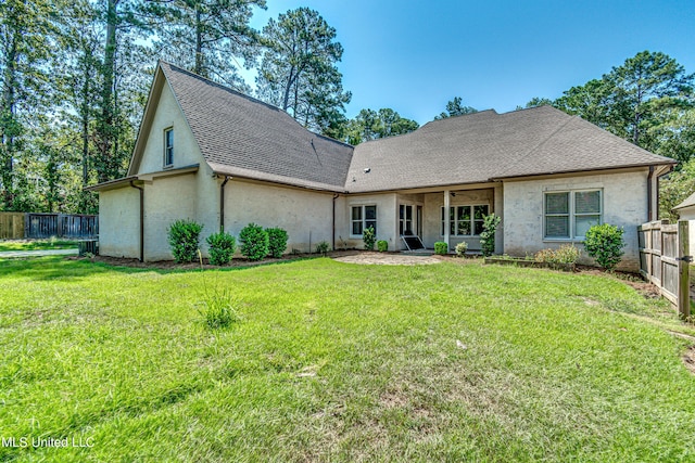 2024 E Northside Dr, Jackson, MS 39211 - rear view of property with a lawn, a fenced backyard, and roof with shingles