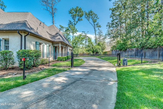 2024 E Northside Dr, Jackson, MS 39211 - view of side of home featuring a gate, a yard, a shingled roof, and fence private yard