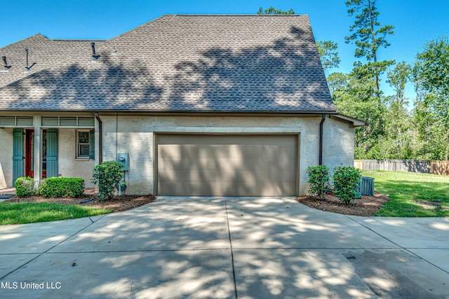 2024 E Northside Dr, Jackson, MS 39211 - view of front of house featuring fence, a front lawn, driveway, roof with shingles, and a garage