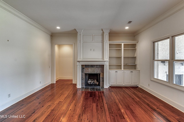 2024 E Northside Dr, Jackson, MS 39211 - unfurnished living room featuring dark wood-style floors, baseboards, recessed lighting, a tile fireplace, and ornamental molding