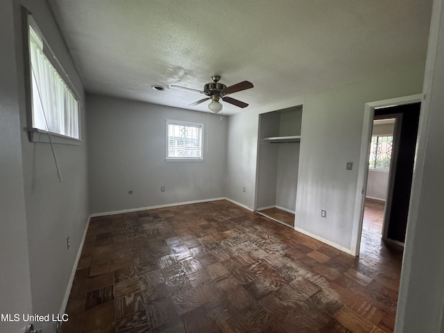 3327 Casa Grande Cir, Jackson, MS 39209 - unfurnished bedroom with a textured ceiling, a closet, baseboards, and a ceiling fan