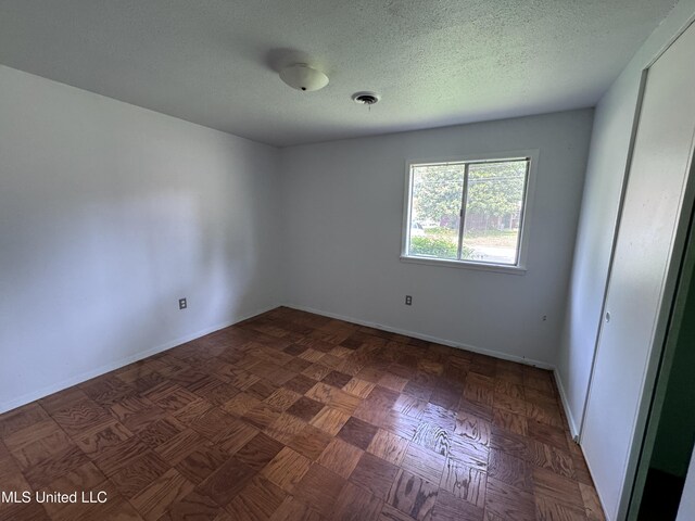 3327 Casa Grande Cir, Jackson, MS 39209 - spare room featuring a textured ceiling and baseboards