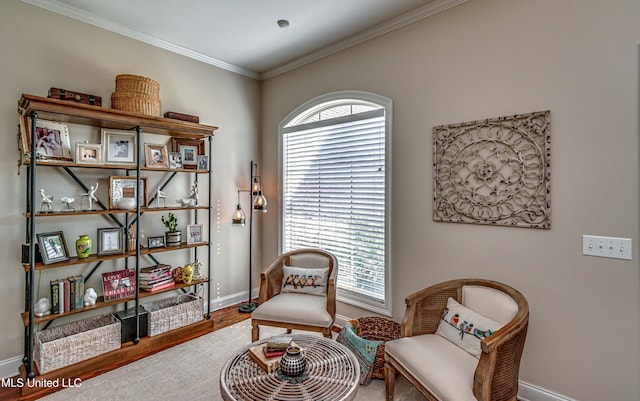 living area with a wealth of natural light, crown molding, and wood-type flooring