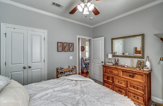 bedroom with a closet, ceiling fan, and ornamental molding