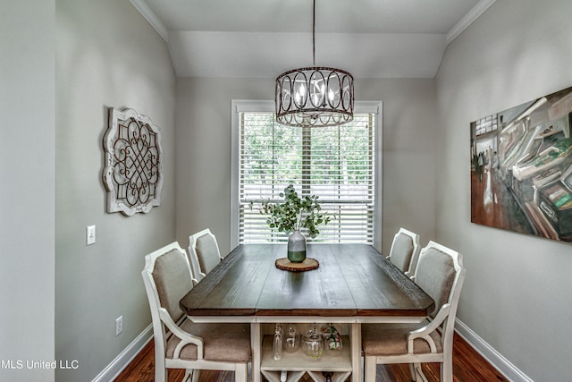 dining room with vaulted ceiling, dark hardwood / wood-style flooring, and an inviting chandelier