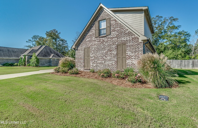 view of property exterior with a lawn