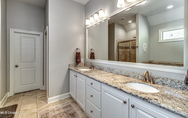 bathroom with vanity, a shower with shower door, and lofted ceiling