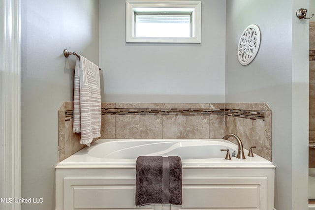 bathroom with a tub to relax in