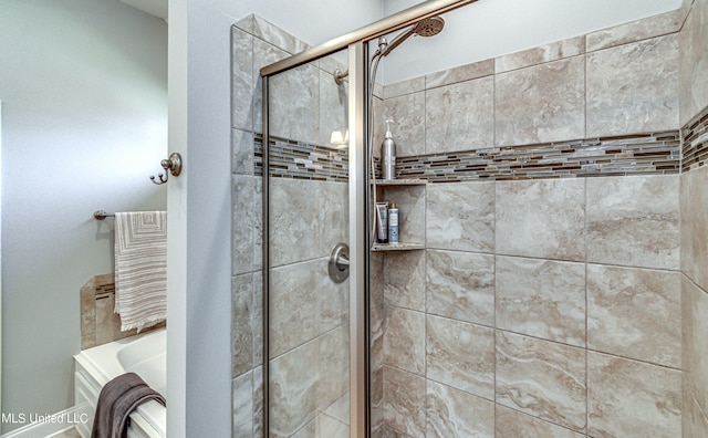 bathroom featuring independent shower and bath