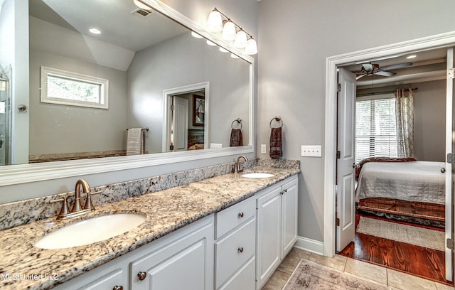 bathroom featuring vanity, hardwood / wood-style floors, lofted ceiling, and ceiling fan