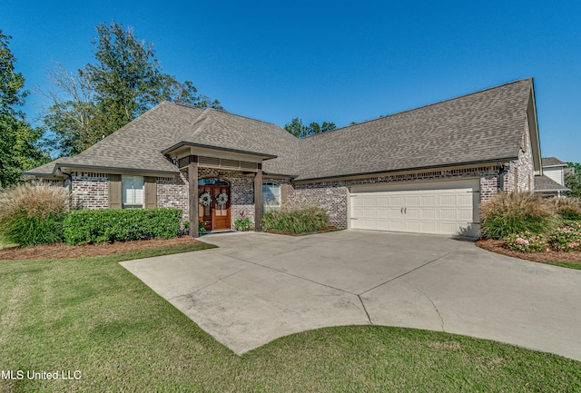 view of front facade with a front yard and a garage