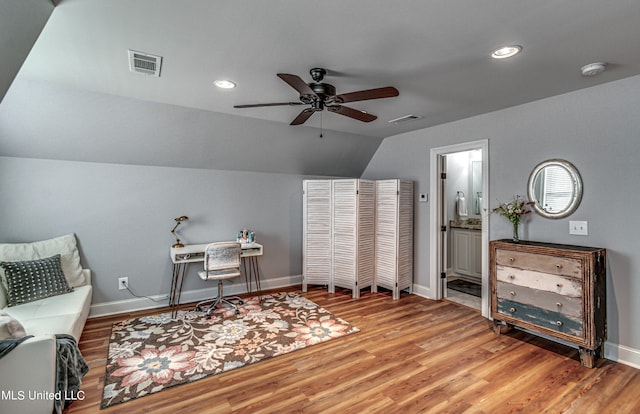 sitting room with hardwood / wood-style floors, vaulted ceiling, and ceiling fan