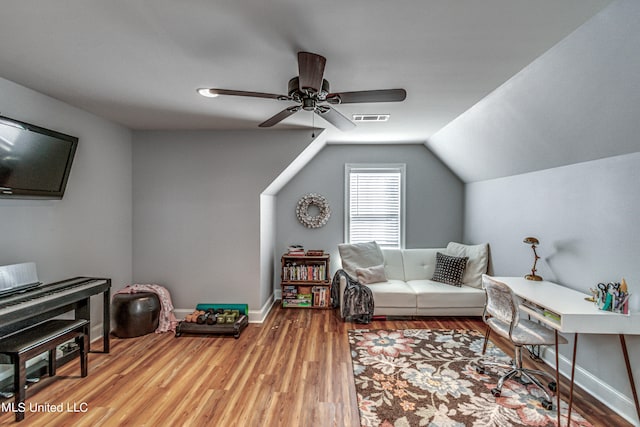 sitting room with ceiling fan, wood-type flooring, and lofted ceiling