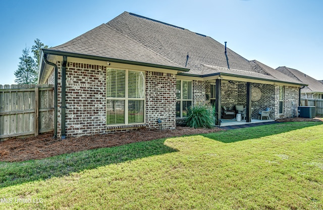 back of property featuring a patio area, central AC unit, and a lawn