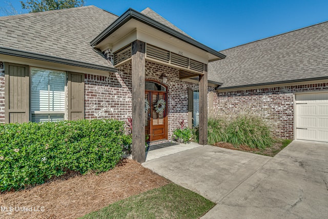 view of exterior entry with a garage