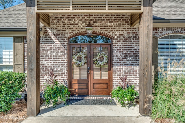 view of exterior entry featuring french doors