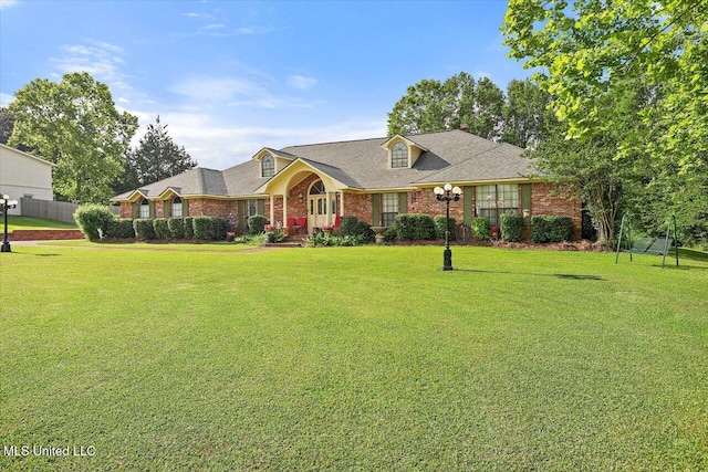 view of front of house featuring a front lawn and brick siding