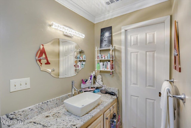 bathroom with crown molding, visible vents, and vanity