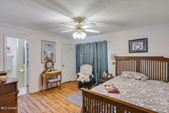 bedroom with a ceiling fan, a textured ceiling, crown molding, light wood-type flooring, and ensuite bathroom