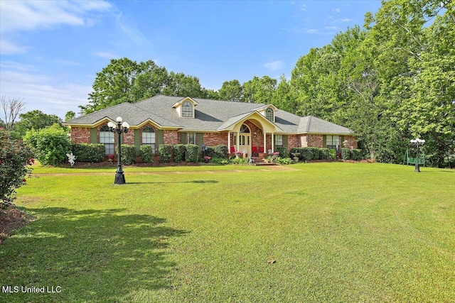 ranch-style house with brick siding and a front yard