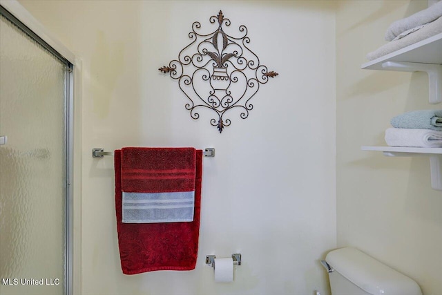 full bath featuring toilet and a shower stall
