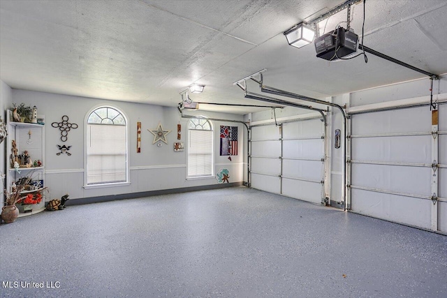 garage featuring a garage door opener and wainscoting