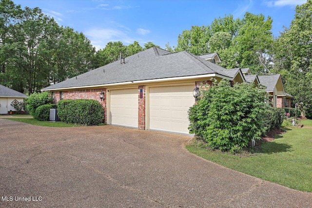 view of property exterior featuring an attached garage, central AC, brick siding, and aphalt driveway