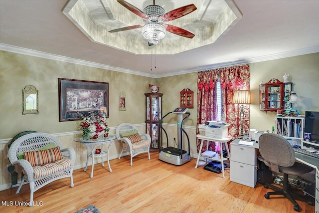 office featuring crown molding, a ceiling fan, a raised ceiling, and wood finished floors