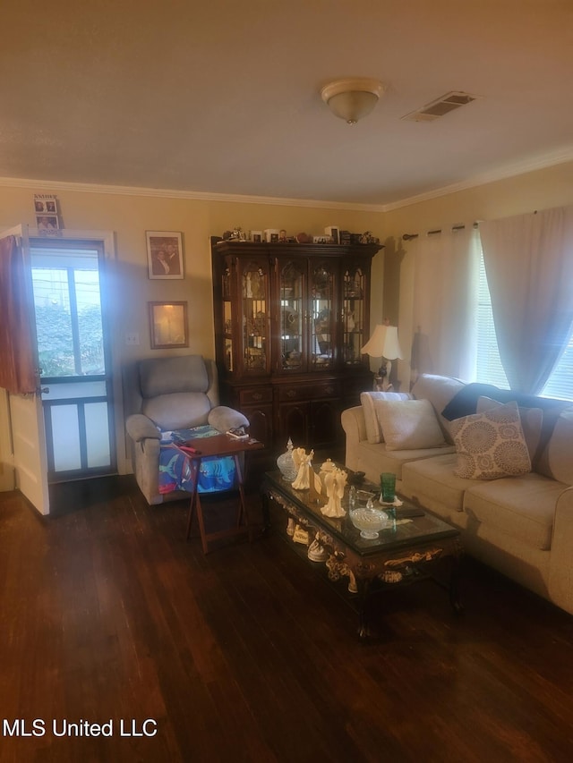 living room with crown molding and hardwood / wood-style floors