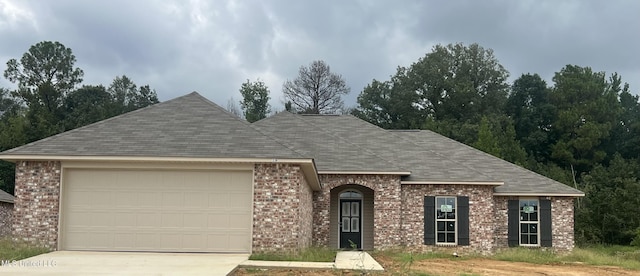 336 Brannan Ave, Byram, MS 39272 - view of front of property featuring brick siding, a shingled roof, concrete driveway, and a garage