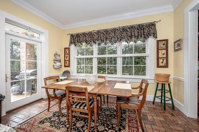 dining area featuring ornamental molding, brick floor, and baseboards