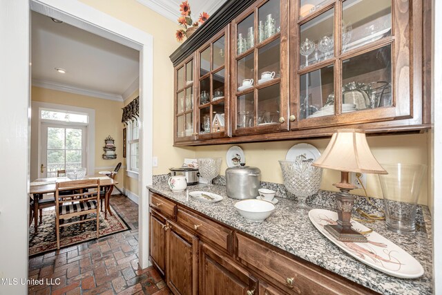 bar with recessed lighting, ornamental molding, brick floor, and baseboards