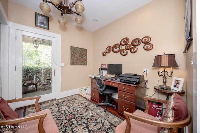 office space featuring a chandelier, baseboards, and wood finished floors