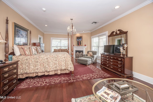 bedroom featuring a chandelier, visible vents, wood finished floors, and crown molding