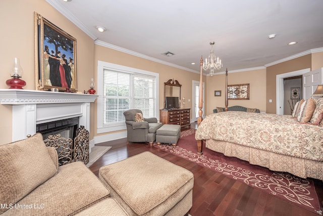bedroom featuring wood finished floors, ornamental molding, a fireplace with raised hearth, visible vents, and a notable chandelier
