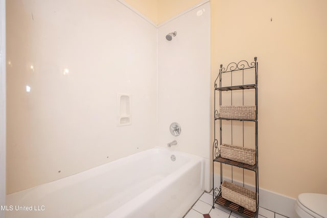 full bath with toilet, tile patterned flooring, and shower / tub combination