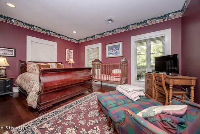 bedroom with wood finished floors, recessed lighting, visible vents, and baseboards