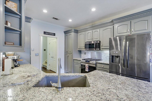 118 Pine Ridge Cir, Brandon, MS 39047 - kitchen featuring stainless steel appliances, a sink, crown molding, gray cabinets, and light stone countertops
