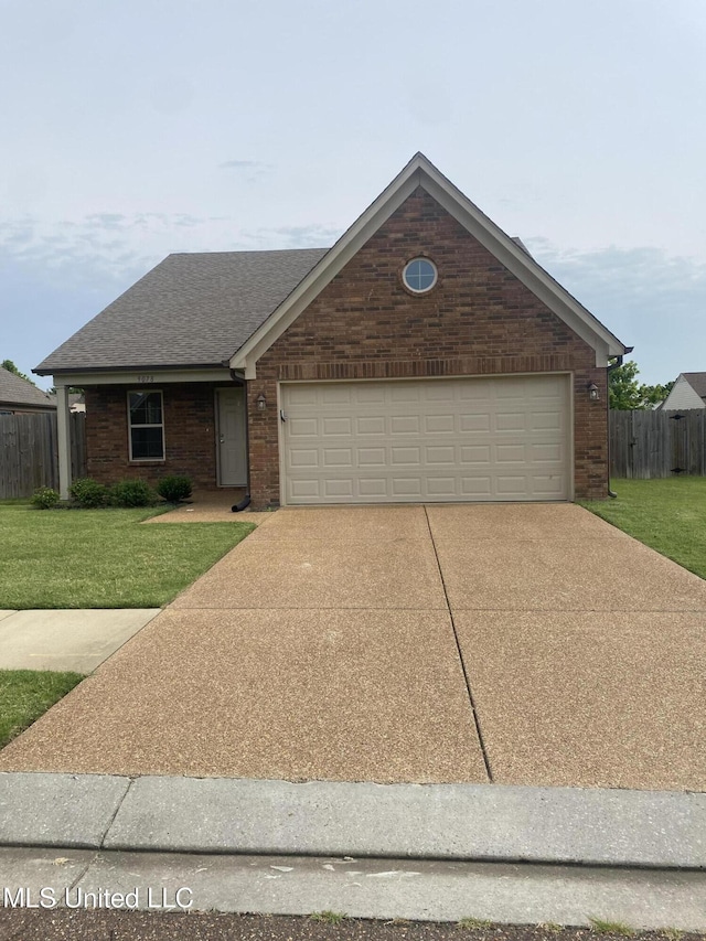 9078 Mallard Park Blvd, Walls, MS 38680 - view of front of property featuring driveway, roof with shingles, a garage, and brick siding