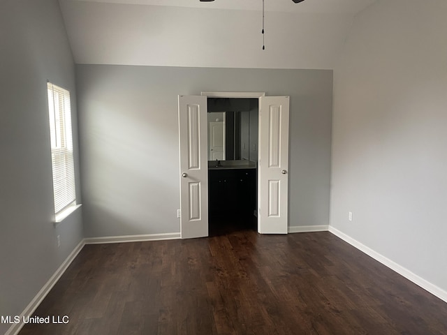 9078 Mallard Park Blvd, Walls, MS 38680 - unfurnished bedroom with vaulted ceiling, dark wood-style flooring, and baseboards