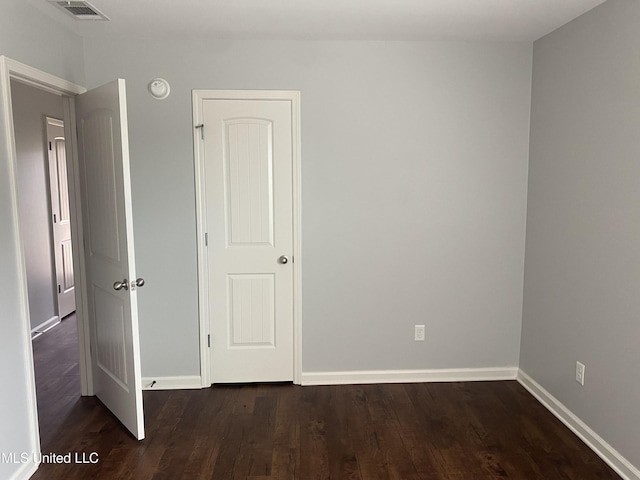 9078 Mallard Park Blvd, Walls, MS 38680 - unfurnished bedroom featuring dark wood-type flooring and baseboards