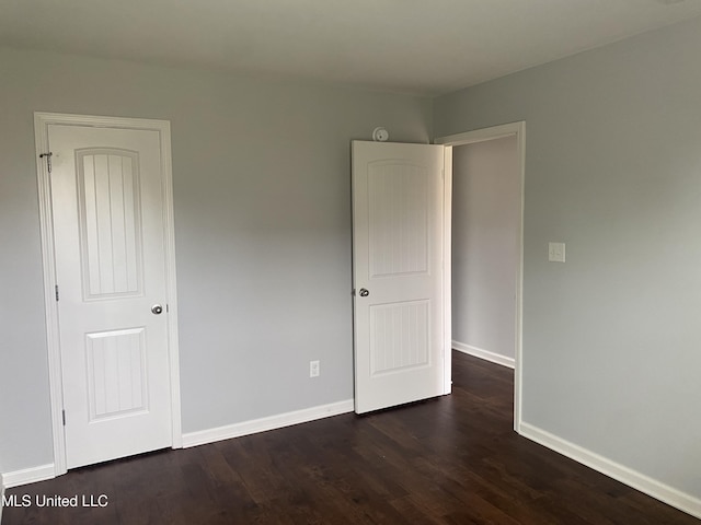 9078 Mallard Park Blvd, Walls, MS 38680 - unfurnished bedroom featuring dark wood-style floors and baseboards