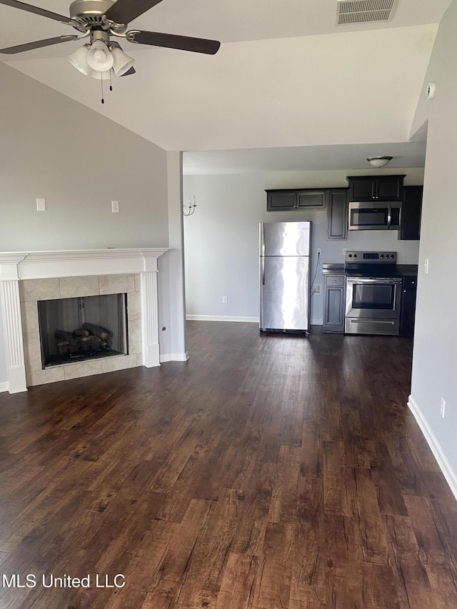 9078 Mallard Park Blvd, Walls, MS 38680 - unfurnished living room featuring a ceiling fan, a tile fireplace, dark wood-style flooring, baseboards, and lofted ceiling